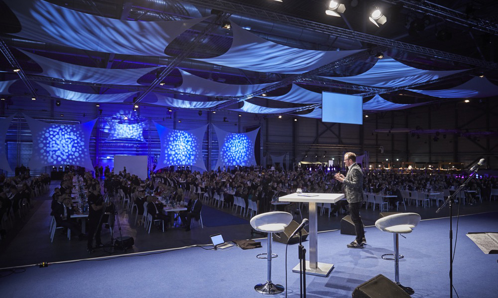 Fabian Hemmert, presenting on a lit stage.